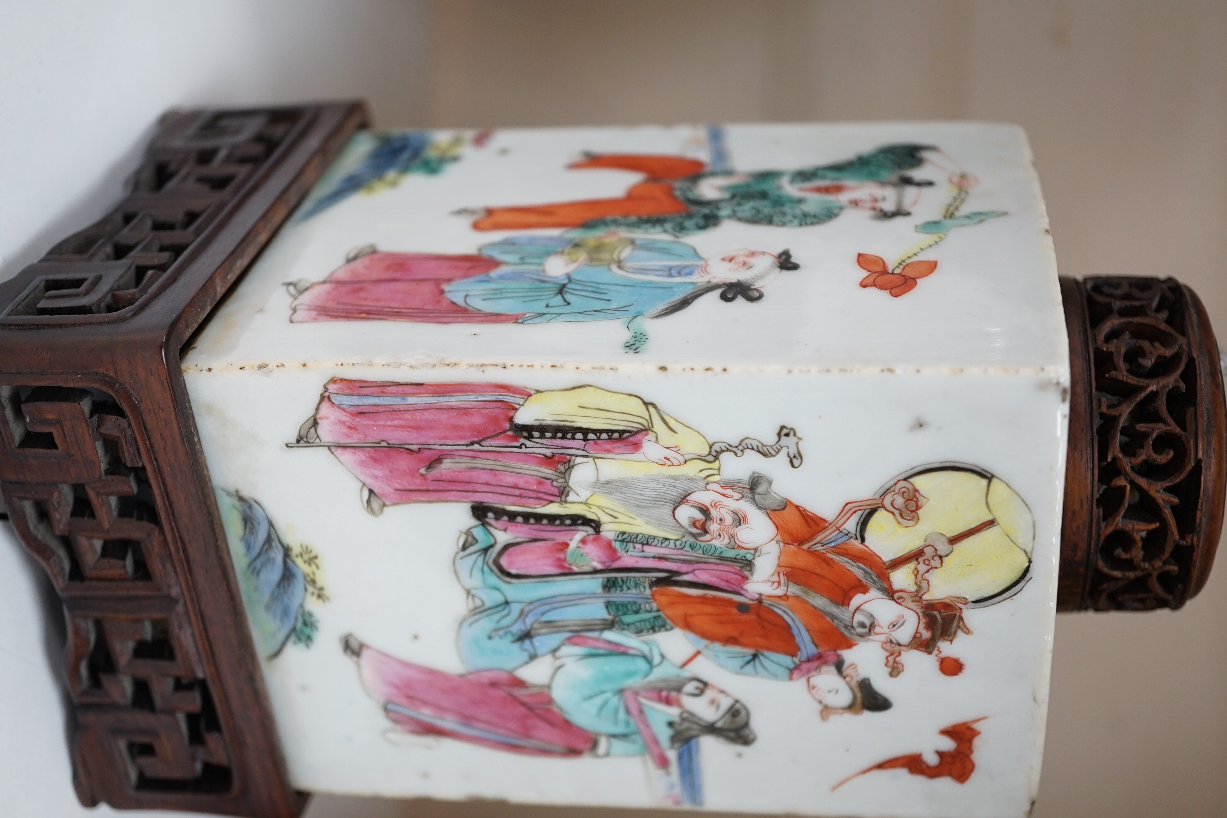A Chinese famille rose square tea caddy, mid 19th century, 13.7cm high excluding wood stand and cover, slight damage
